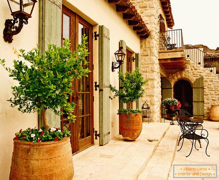 ўнутраны дворык в средиземноморском стиле украшают горшки с живыми растениями. Привлекательный дизайн, мебель с витиеватыми спинками, керамические горшки создают уютную, расслабляющую атмосферу. 